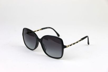 CHANEL
Pair of black resin and gold metal...