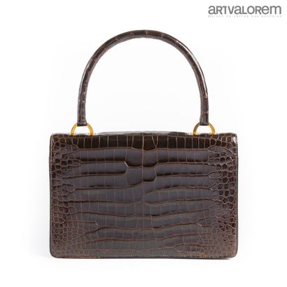 HERMÈS Paris
Ring bag in brown Porosus crocodile
Brown...