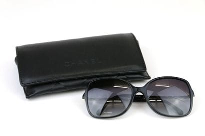 CHANEL
Pair of black resin and gold metal...
