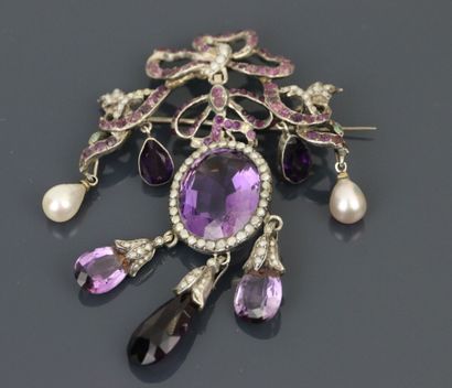 Silver brooch in the form of knots paved...