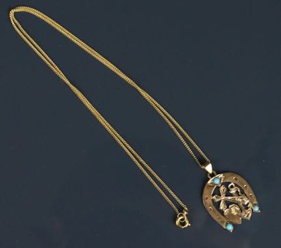 Chain and horseshoe pendant adorned with...
