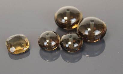 One round faceted smoky quartz and four smoky...
