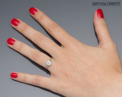 Platinum solitaire set with a claw-set brilliant-cut...