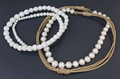 Long necklace adorned with white freshwater...