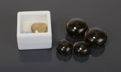 One round faceted smoky quartz and four smoky...