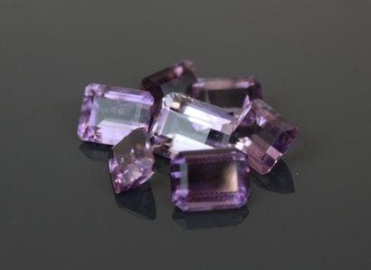 7 lilac-colored emerald-cut amethysts 
one...