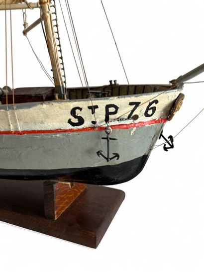 Single-sailed wooden fishing boat, hull painted...