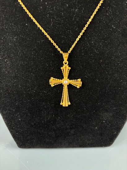 Cross in yellow gold 750°/°° set with a half...