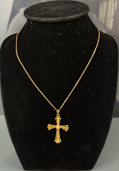 Cross in yellow gold 750°/°° set with a half...