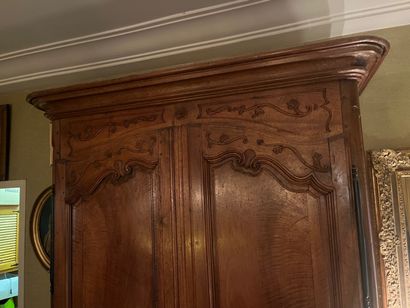 Natural wood cabinet carved with acanthus...