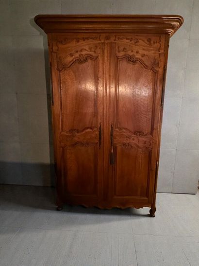 Natural wood cabinet carved with acanthus...