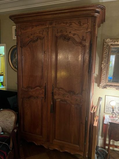Natural wood cabinet carved with acanthus...