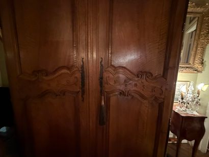 Natural wood cabinet carved with acanthus...