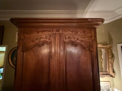 Natural wood cabinet carved with acanthus...