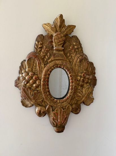 Small gilded and carved wooden mirror decorated...