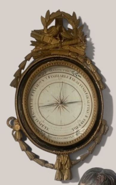 A gilded and black-lacquered wooden barometer...