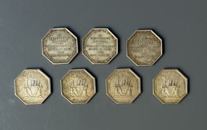 Seven silver tokens, four 
