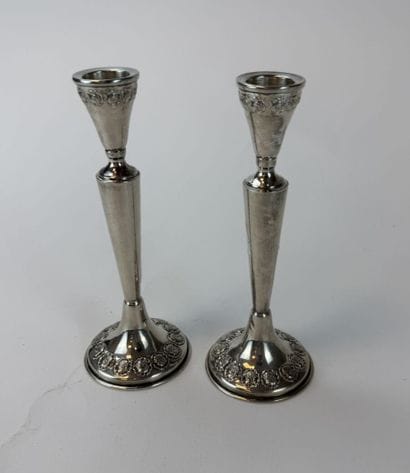 Pair of 800°/°° silver candlesticks, decorated...