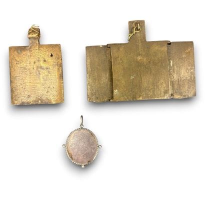 A votive plaque and an engraved brass votive...