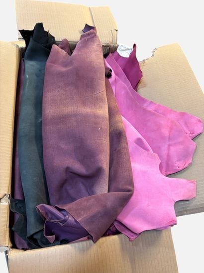 [LEATHER HANDLE]
Box containing goat hides...