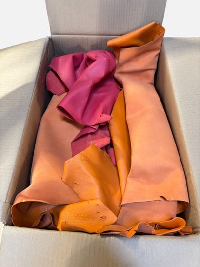 [LEATHER HANDLE]
Box containing goat hides...