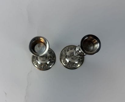 Pair of 800°/°° silver candlesticks, decorated...