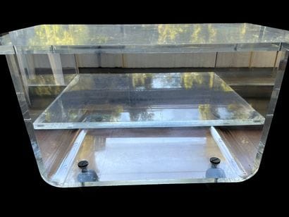 Clear plexiglass table with two shelves,...