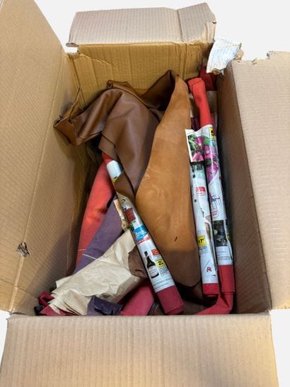 [LEATHER HANDLE]
Box containing goat hides...