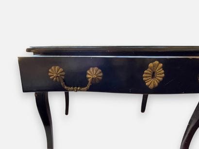 Blackened wooden desk with a drawer that...