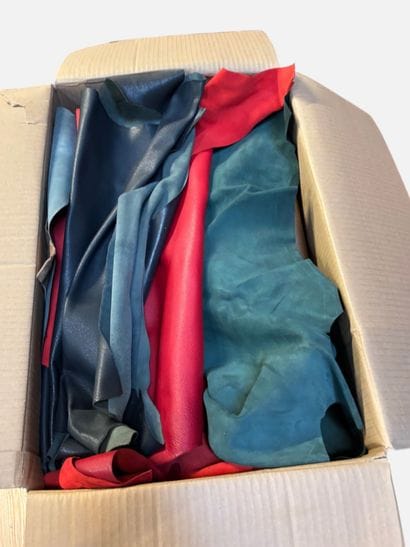 [LEATHER HANDLE]
Box containing goat hides...