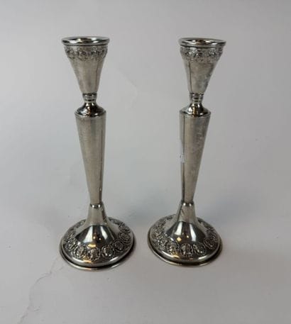 Pair of 800°/°° silver candlesticks, decorated...