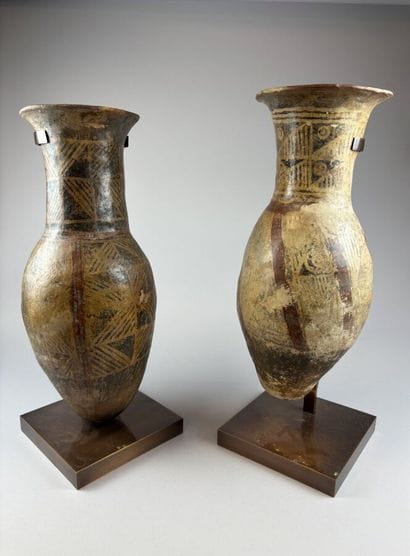 Two terracotta urns with geometric decoration,...