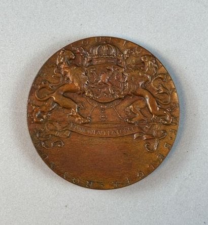 [MEDAL]
Circular bronze medal with a brown...
