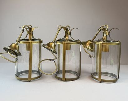 Set of three cylindrical lanterns made of...