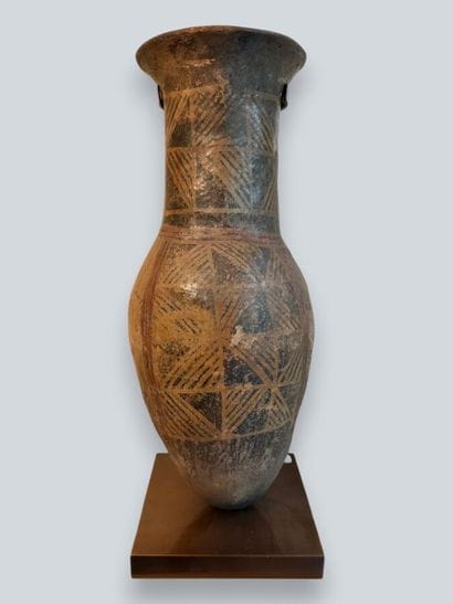 Two terracotta urns with geometric decoration,...