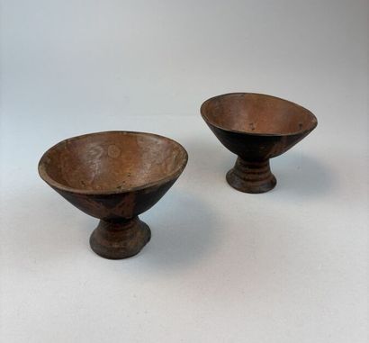 Two terracotta cups on a pedestal with geometric...
