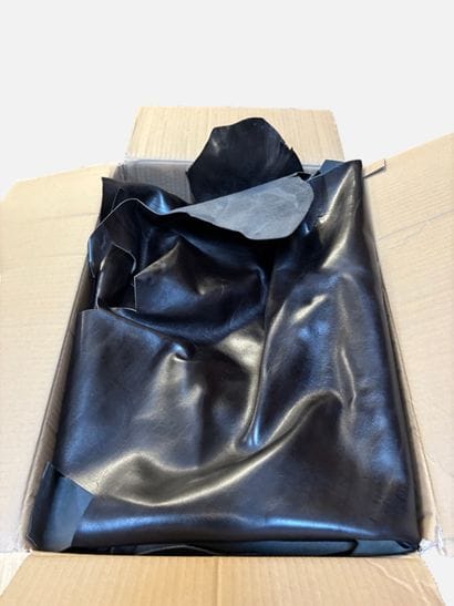 [LEATHER HANDLE]
Box containing goatskins...