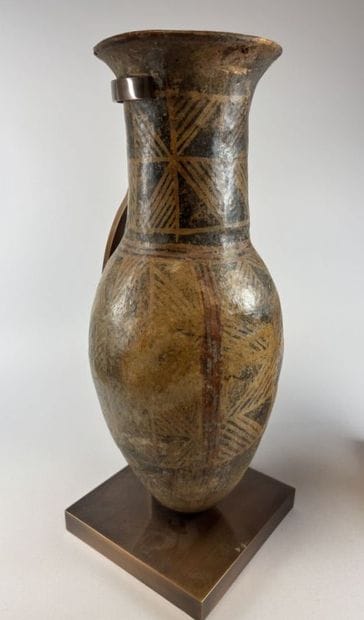 Two terracotta urns with geometric decoration,...