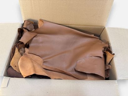[LEATHER HANDLE]
Box containing goat hides...