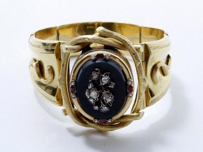 Bracelet articulé en or 18 K, centré d'une...