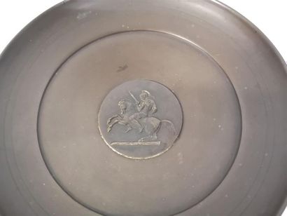 Coupe en bronze, au fond un cavalier à l'antique....