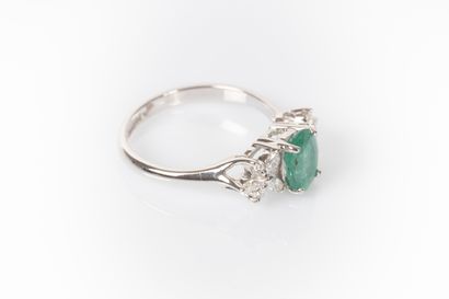 White gold ring set with an oval emerald...