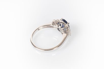 White gold ring set with a natural oval sapphire...