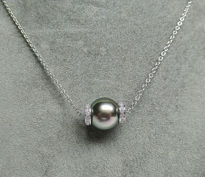 White gold pendant on its chain adorned with...