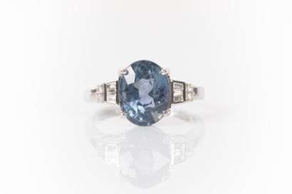 White gold ring set with a natural oval sapphire...