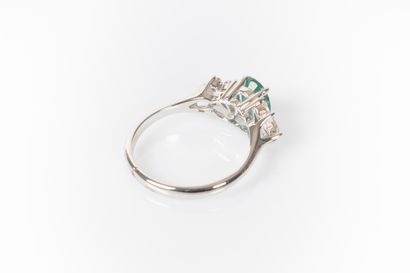 White gold ring set with an oval emerald...