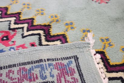 Wool carpet with geometric design on a blue...