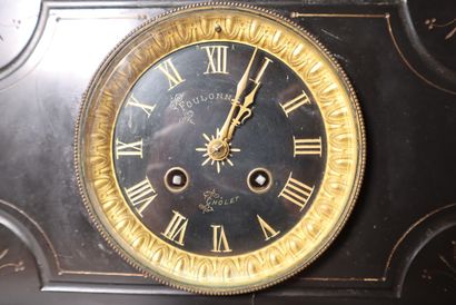 Black marble clock, subject in composition...