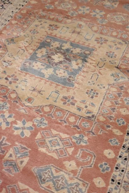 Oriental wool carpet with pink background....