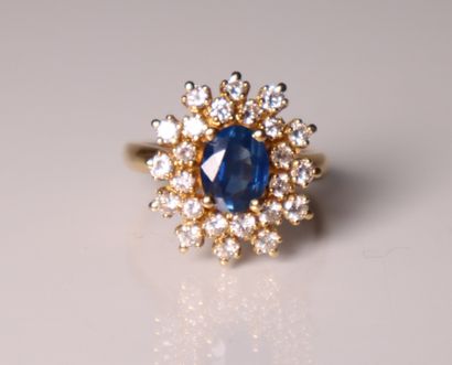 Yellow gold daisy ring set with a sapphire...